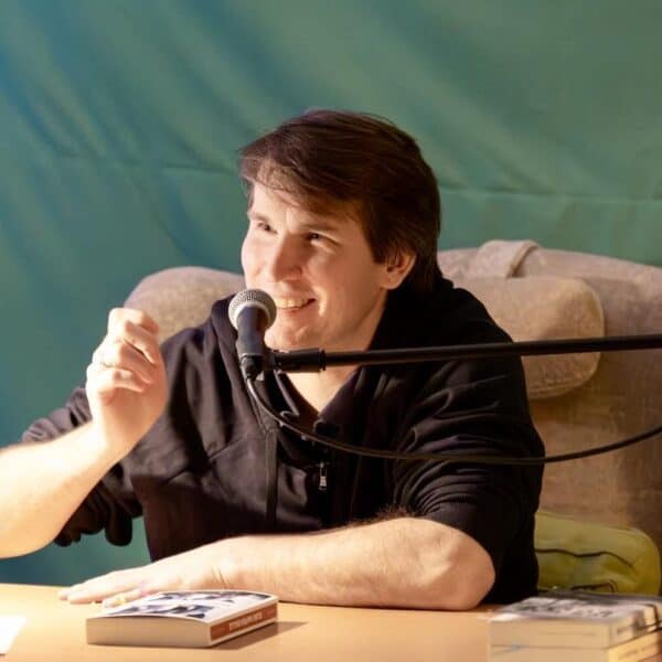 Hedda Anders liest bei einer Veranstaltung, begleitet von Ben Westphal, in einem gemütlichen Rahmen.