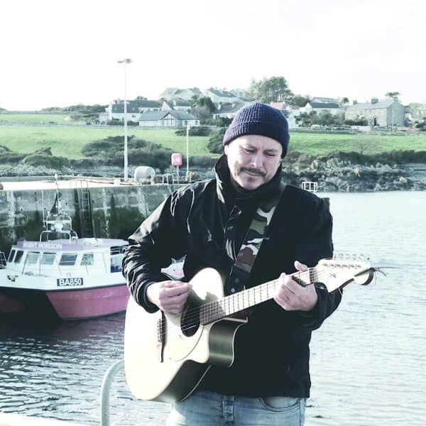 Musiker spielt Gitarre am Hafen, maritime Kulisse, Chester Bingley.